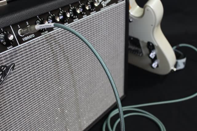 Guitar cable plugged into an amplifier